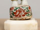 a figurine of a man and woman standing on a pedestal