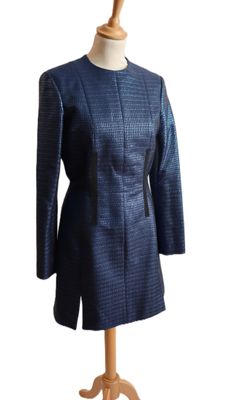 blue jacket on a mannequin stand on a white background