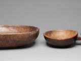 two wooden bowls and a bowl on a gray surface
