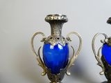 two blue vases sitting on top of a table