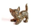 a small statue of a cat on a white surface