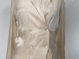 a mannequin with a jacket on it on a wooden stand