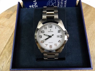 the watch is in the box on the table ready to be used