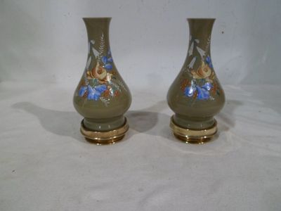 two vases that are sitting on a white surface