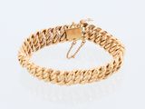 a gold chain bracelet with a clasp on a white background