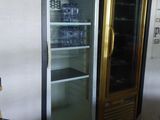 a refrigerator that is sitting in the corner of a room