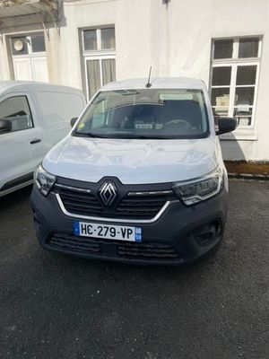 the white van is parked in front of a white building