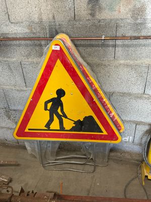 a yellow and red sign that is on the side of a building