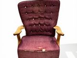 a purple chair with a wooden frame on a white background
