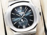 a silver watch with a black dial on it