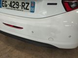 a white car with a number plate on the back of it