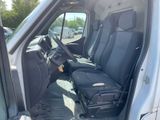 a seat in the back of a van with luggage in it
