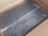 a cardboard box with a laptop in it sitting on the floor