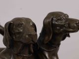 two dogs that are sitting next to each other