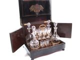 a box that has a set of glasses and a decanter in it