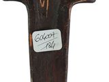 wooden cross on a white background with a sticker on it