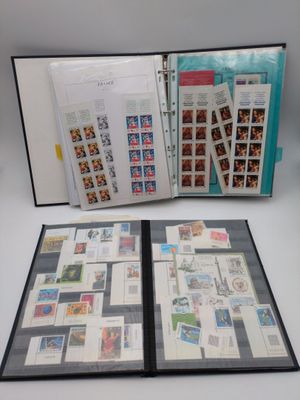 an open book with stamps on it sitting on top of a table