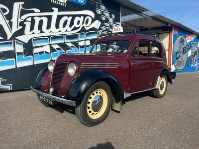 une vieille voiture garée devant un immeuble
