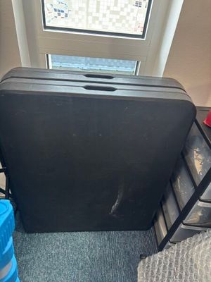 a piece of luggage sitting on the floor next to a window