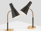 a pair of black lamps on a white surface