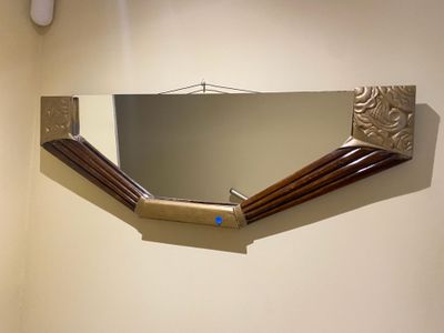 a mirror on the wall above a sink in a bathroom