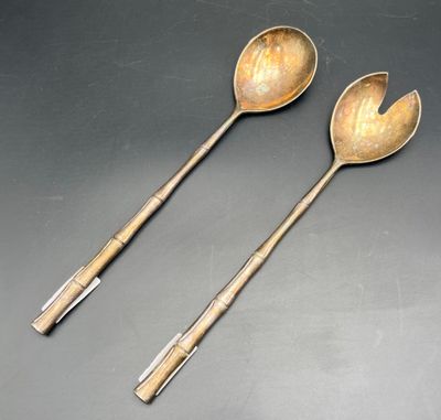 two spoons and a spoon rest on a table
