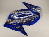 a close up of a blue and gold scarf on a white surface
