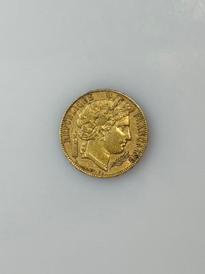a close up of a gold coin on a white surface