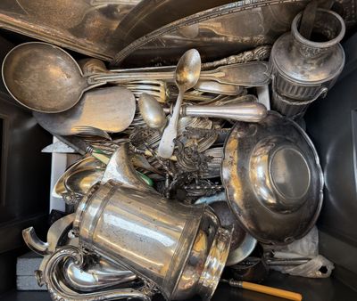 a pile of old silverware in a black box