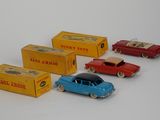 several toy cars are lined up next to each other on a white surface