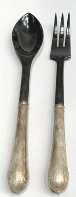 two forks and a spoon sitting next to each other