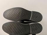 someone is wearing a pair of shoes that are on top of a box