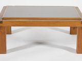 a small wooden table with a glass top on a white background