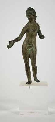 statue of a boy holding a ball on a pedestal