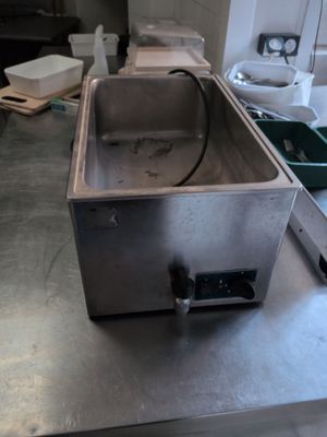 a metal sink sitting on a counter in a kitchen