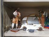 a shelf with a toy car and a figurine on it