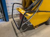 a yellow machine that is sitting in the garage