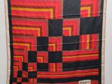 an image of a red, black, and orange quilt
