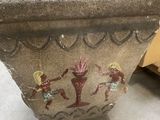 a stone planter with a painting on it