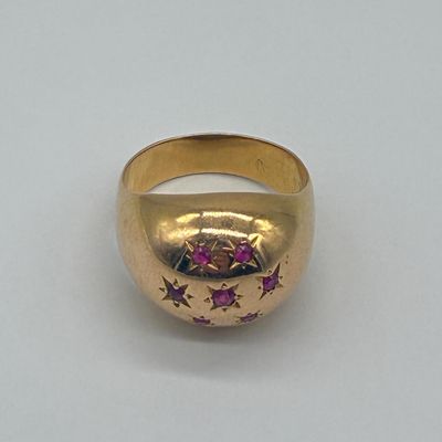 an image of a close up of a gold ring on a white surface