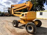a yellow crane that is sitting in the dirt