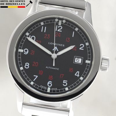 a close up of a watch with a black face