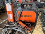 an orange and black welding machine sitting on top of a table next to other tools