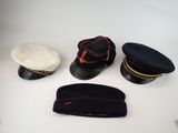 several hats are lined up on a table with a hat on top of them