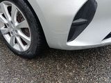 a close up of a car ' s front bumper and tire