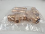 a bag of brass fittings sitting on a table