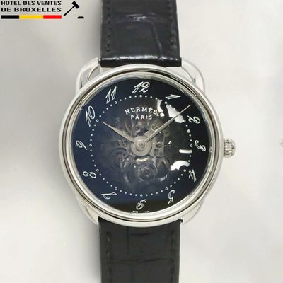 a close up of a wrist watch with a black dial