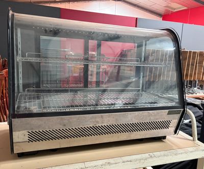 a display case with a lot of food inside of it