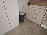 a small kitchen with a refrigerator, sink, and refrigerator freezer