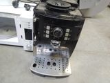 a coffee machine that is sitting on the floor next to a microwave